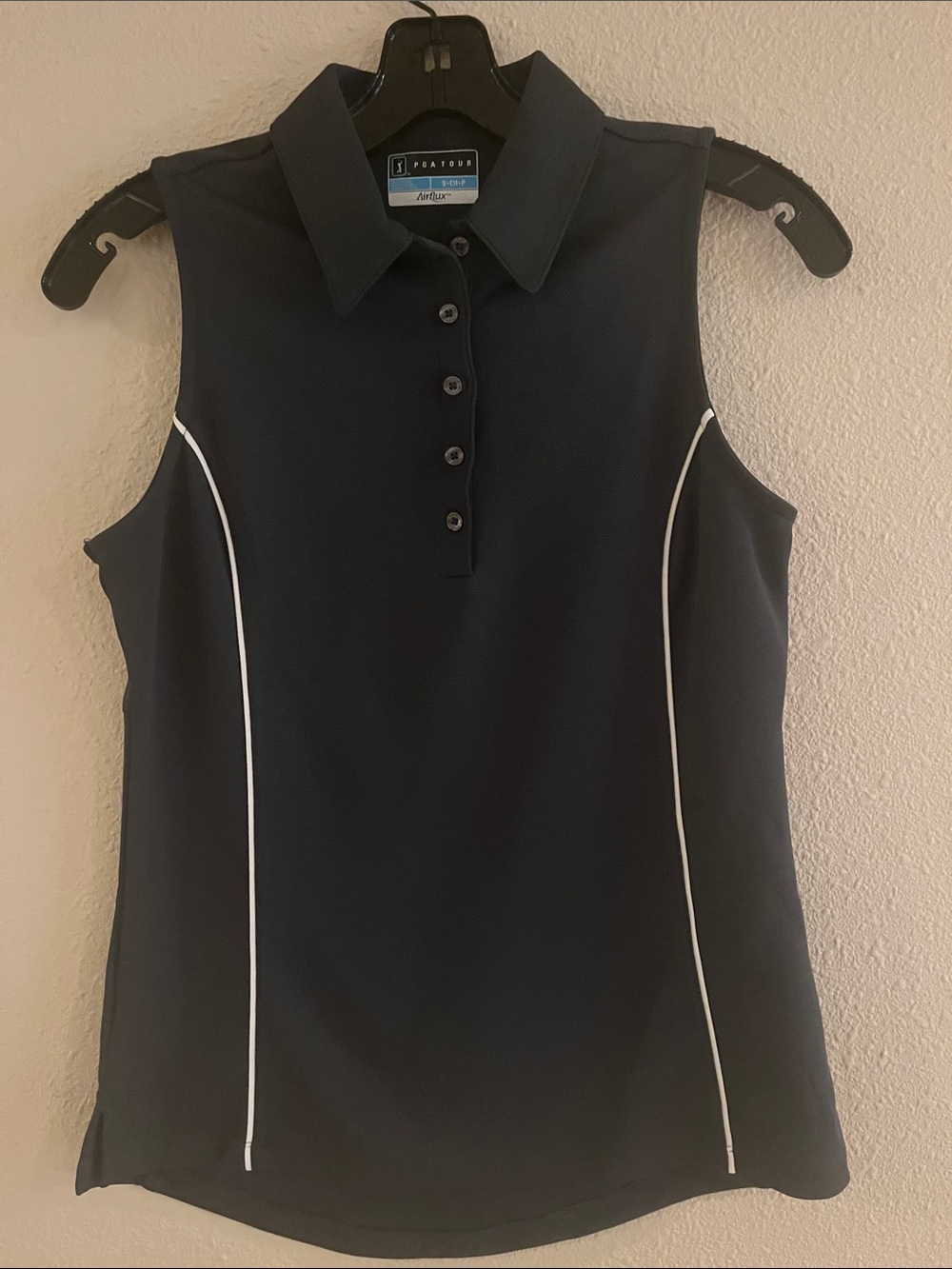 Women’s dark gray Sleeveless Polo with White Piping. PGA Tour